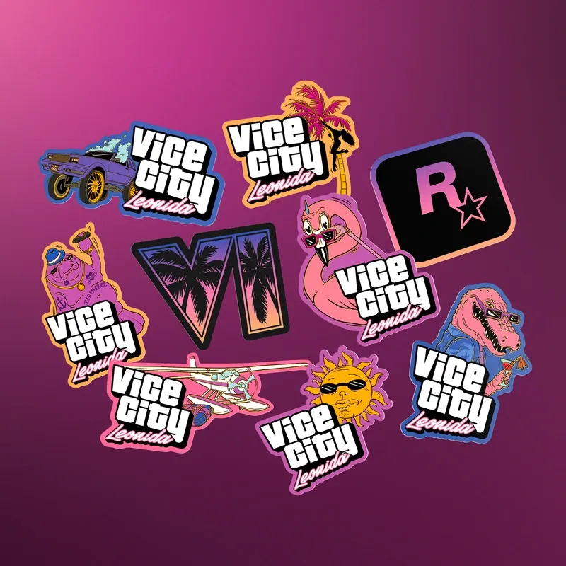 Nueve pegatinas extendidas sobre fondo rosa: el logotipo VI con palmeras, el de Rockstar y varias con el rótulo «Vice City Leonida» junto a un coche, un flamenco, el caimán Macca, un manatí, un hidroavión y un sol con gafas.